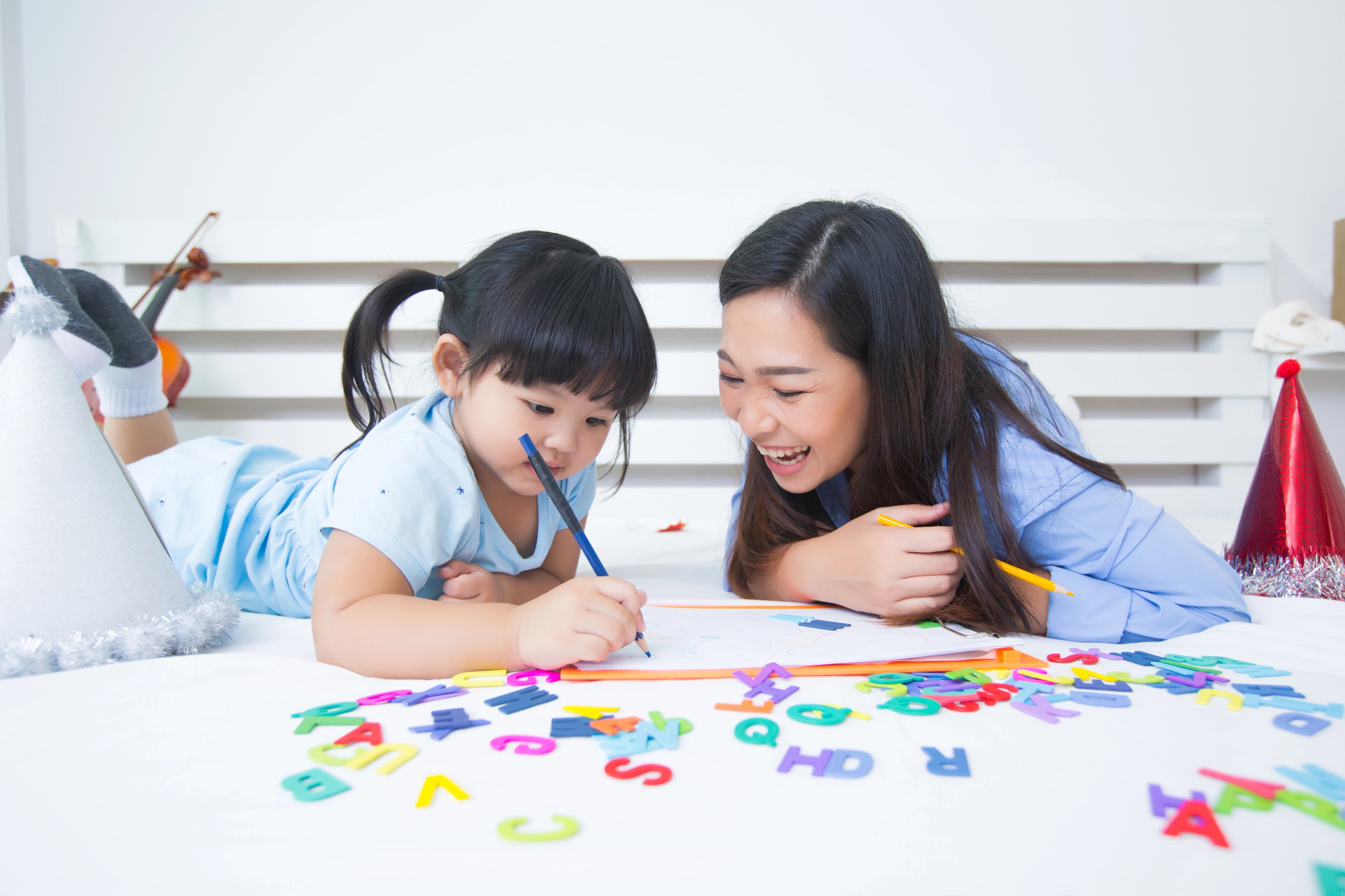 A child reading and writing at a desk — the language skills across all four PSLE English papers.